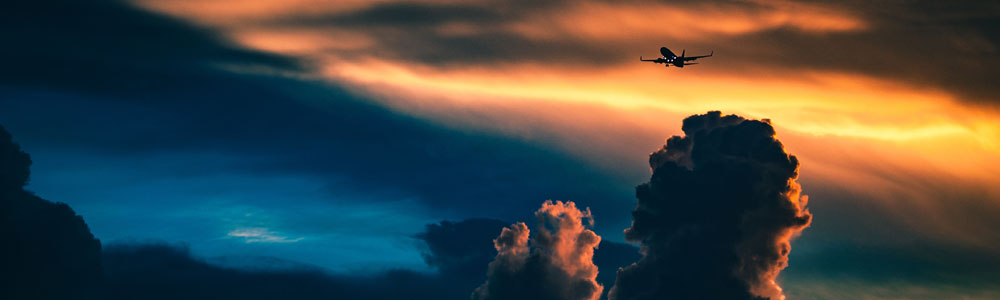 Airline flying at sunset